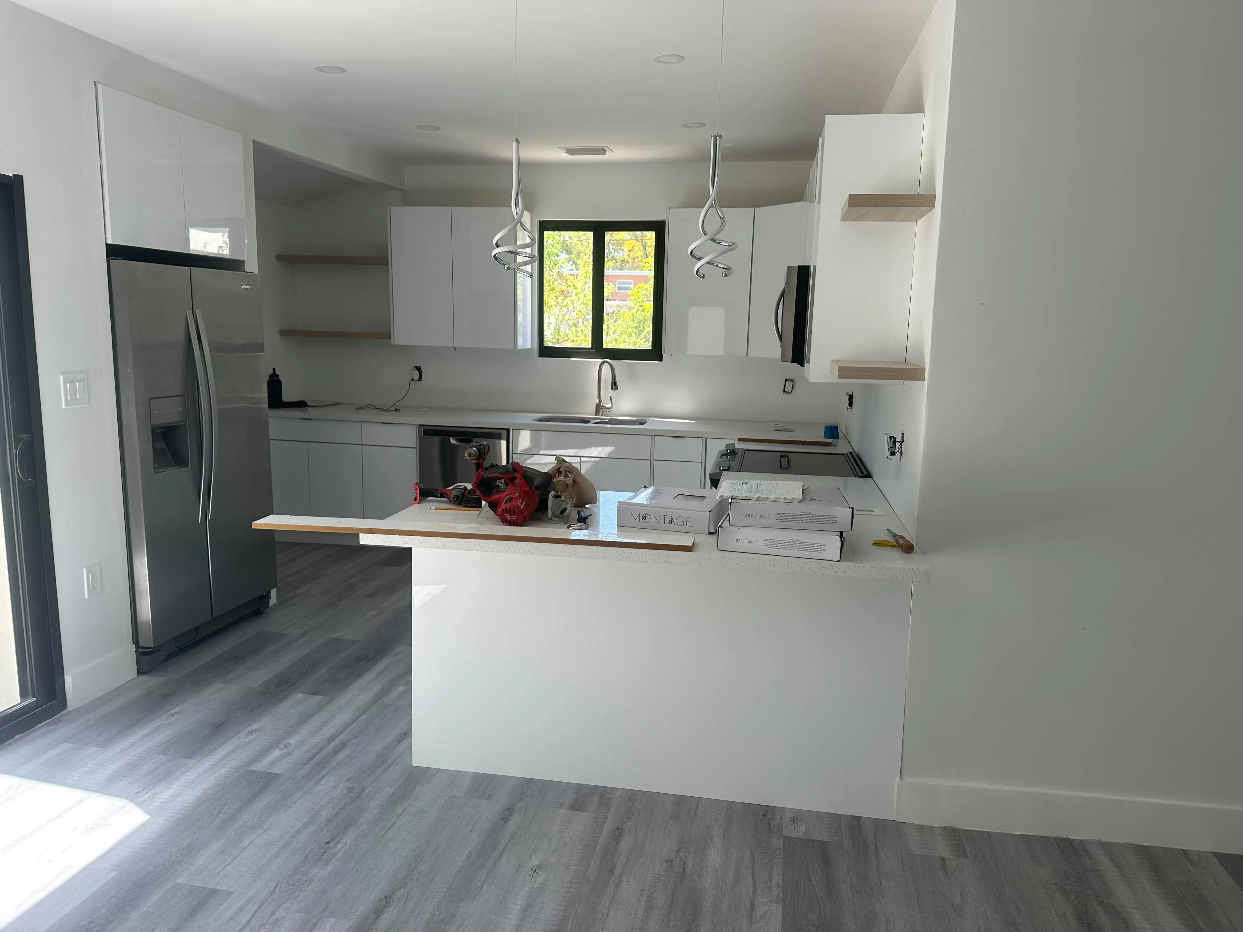 Open kitchen with white cabinets and an island