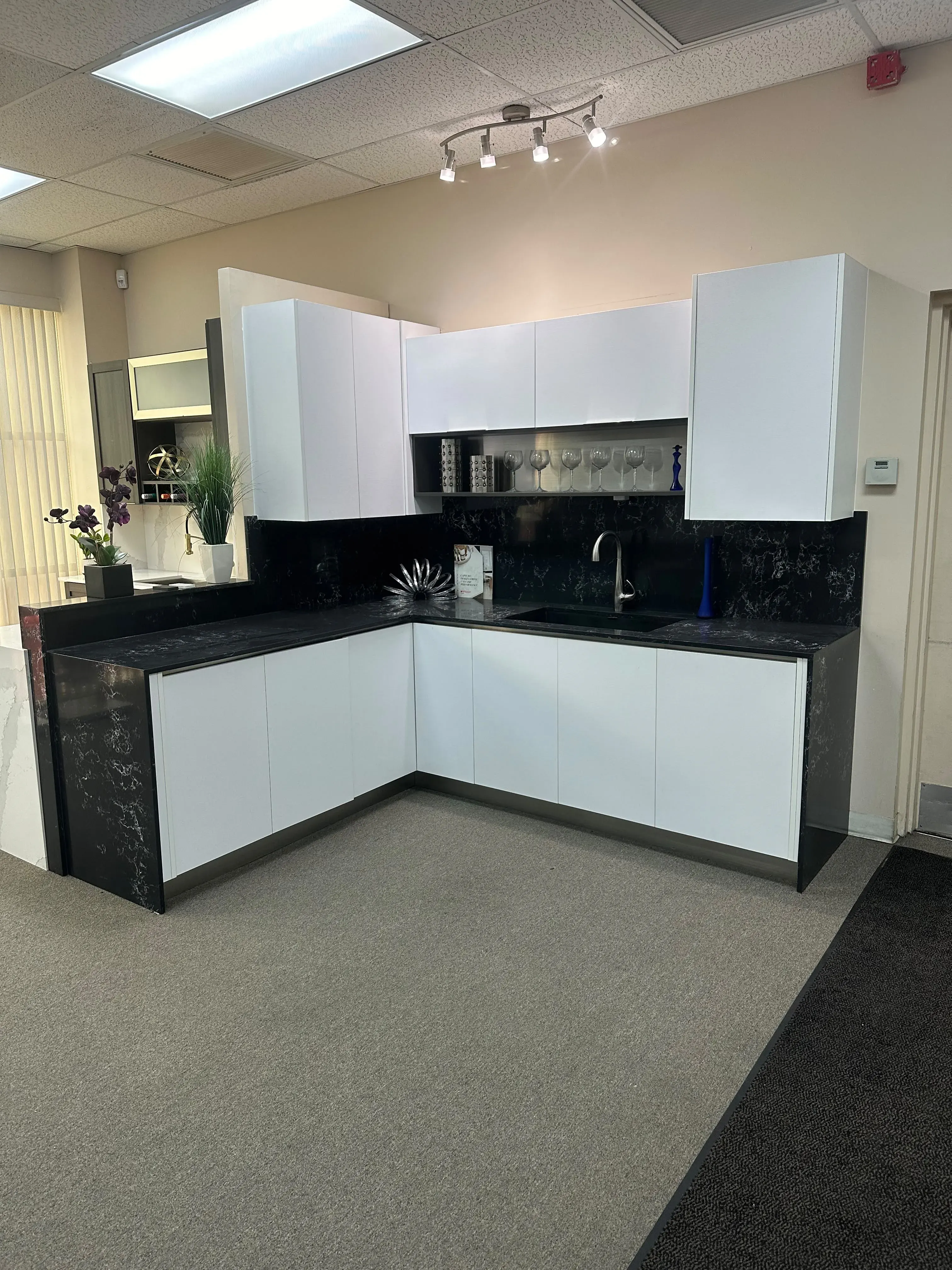 White and black L-shaped kitchen cabinets
