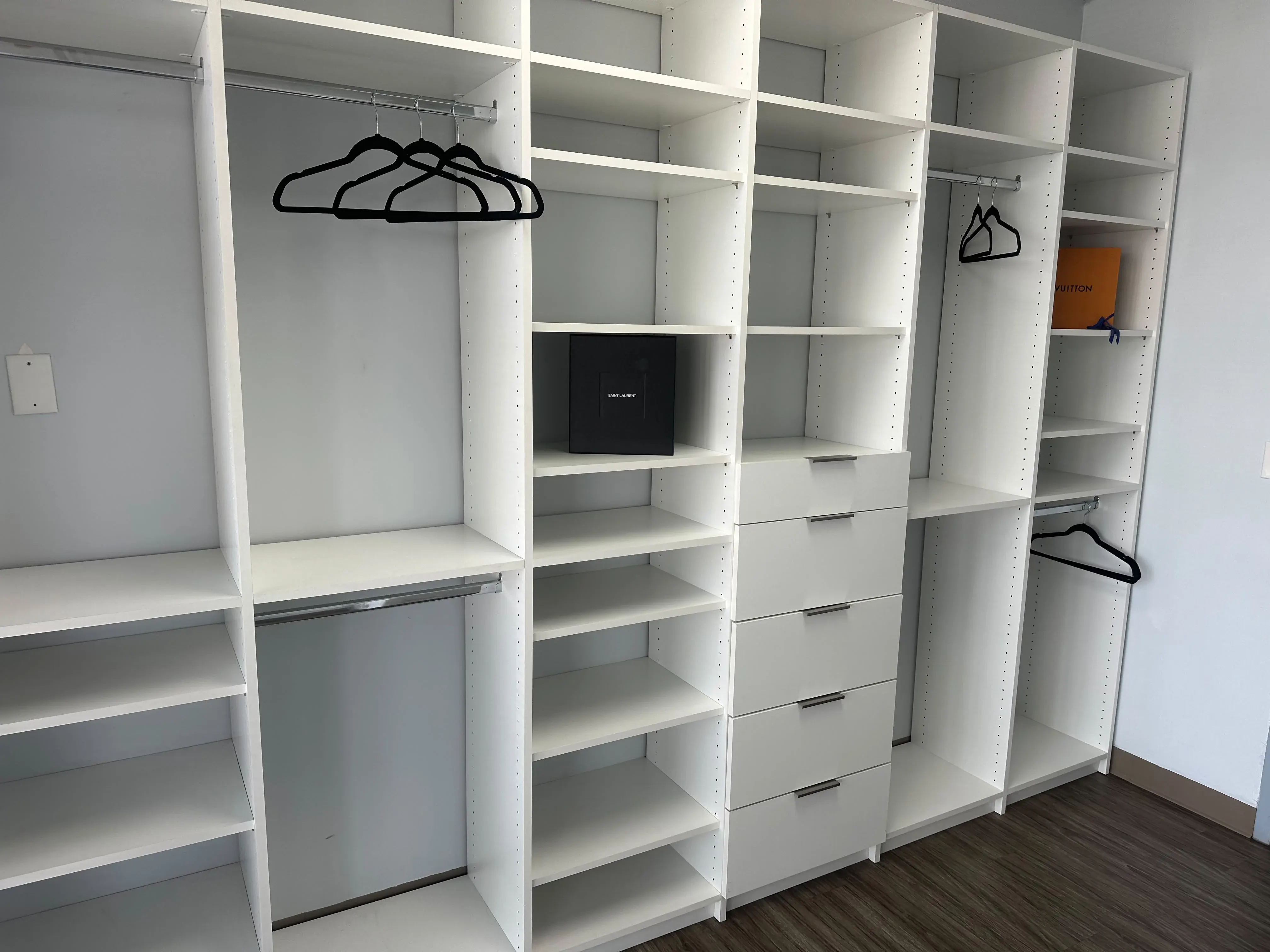 Built-in white closet shelving with drawers