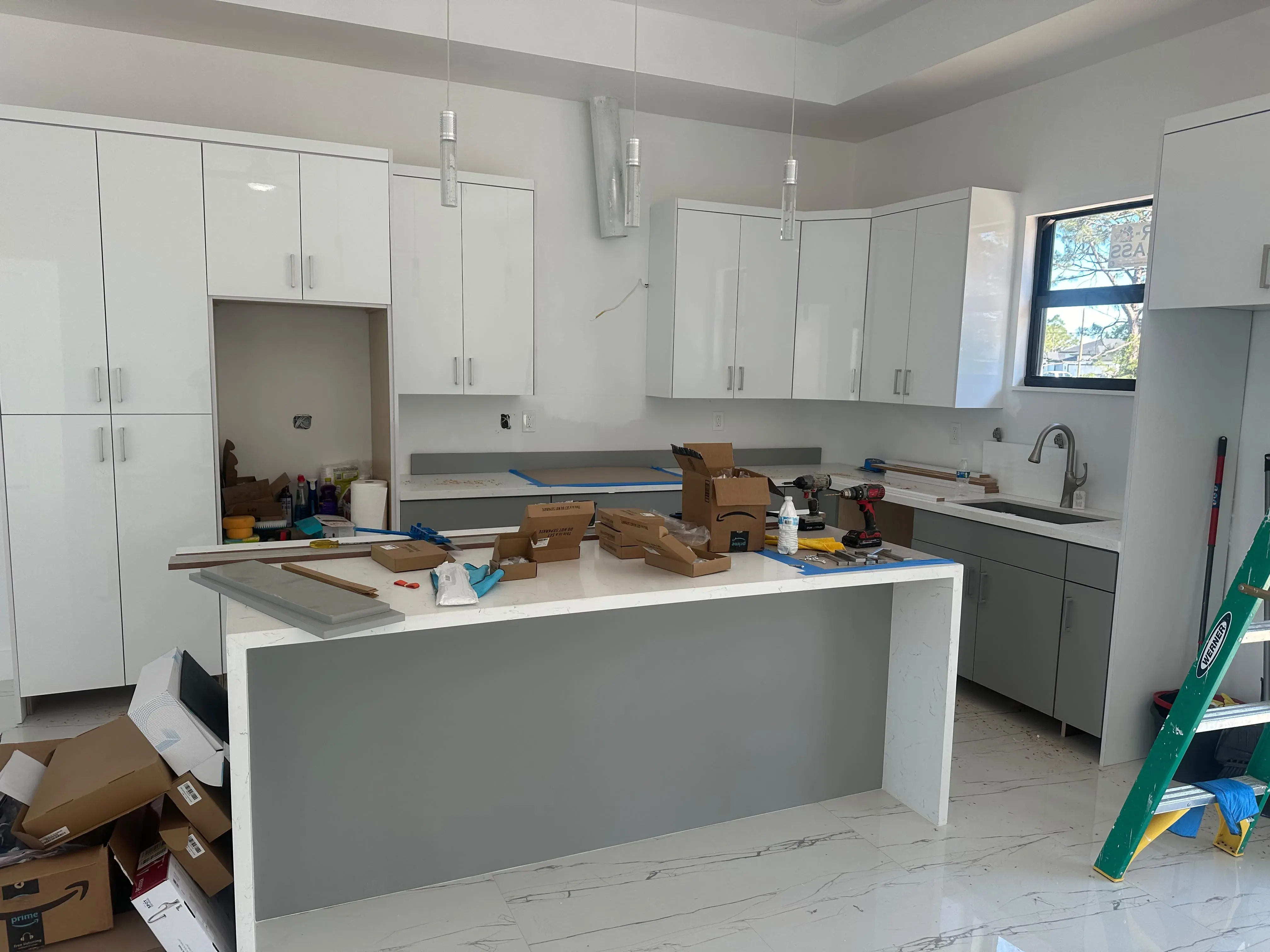 White kitchen with an island and shaker cabinets