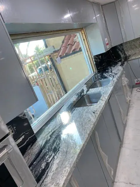 Kitchen with a granite countertop under a window