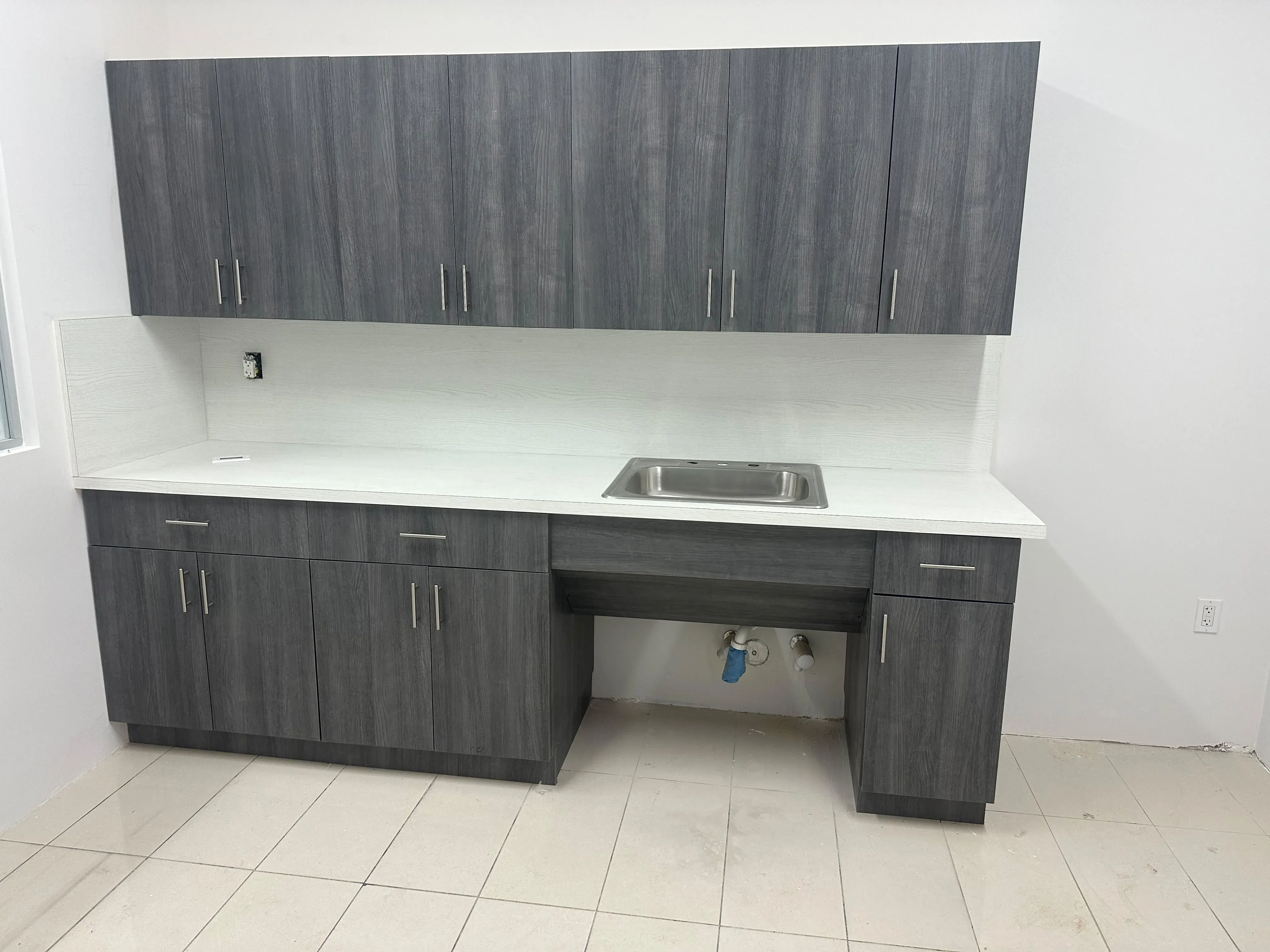 Gray wood-grain cabinets with a counter in an office