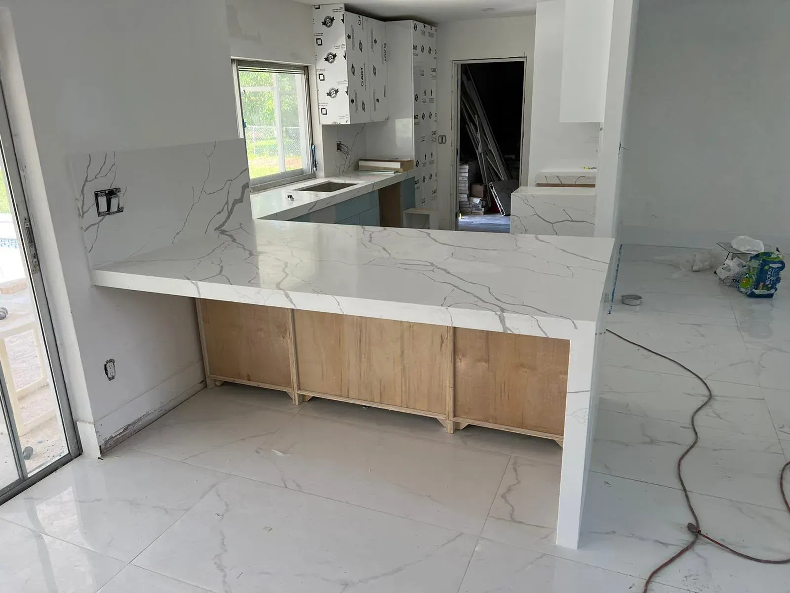 Marble countertop bar with a wood cabinet base