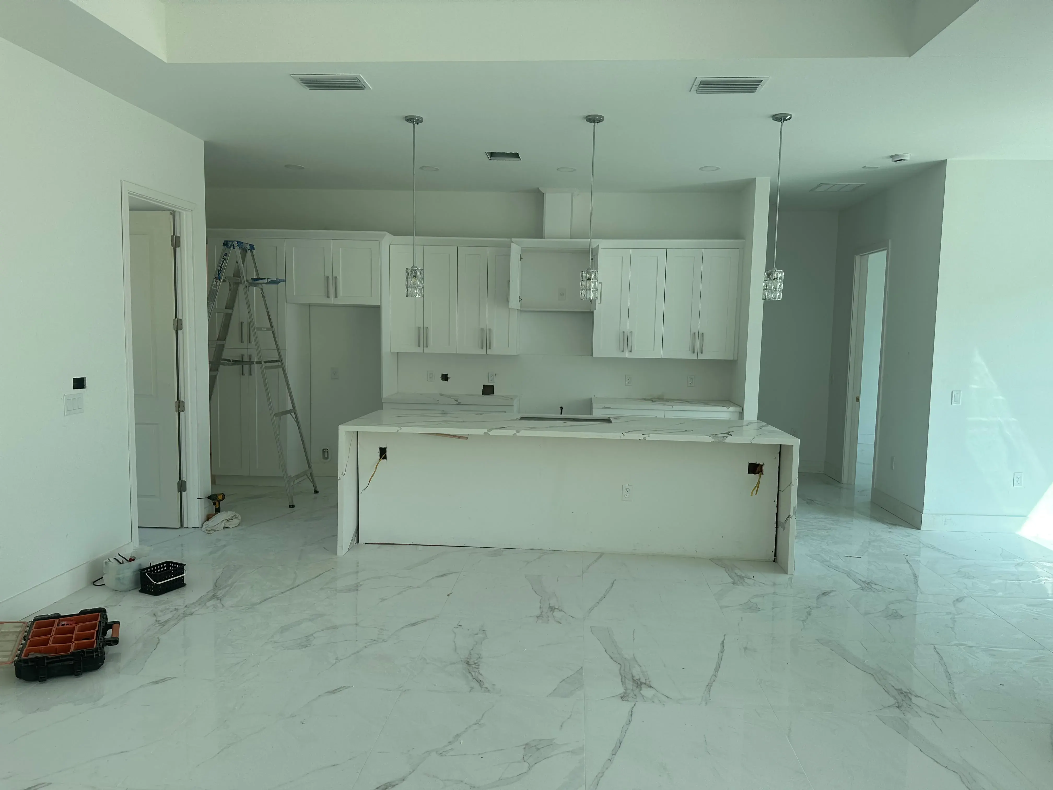 Open kitchen with white cabinets and an island