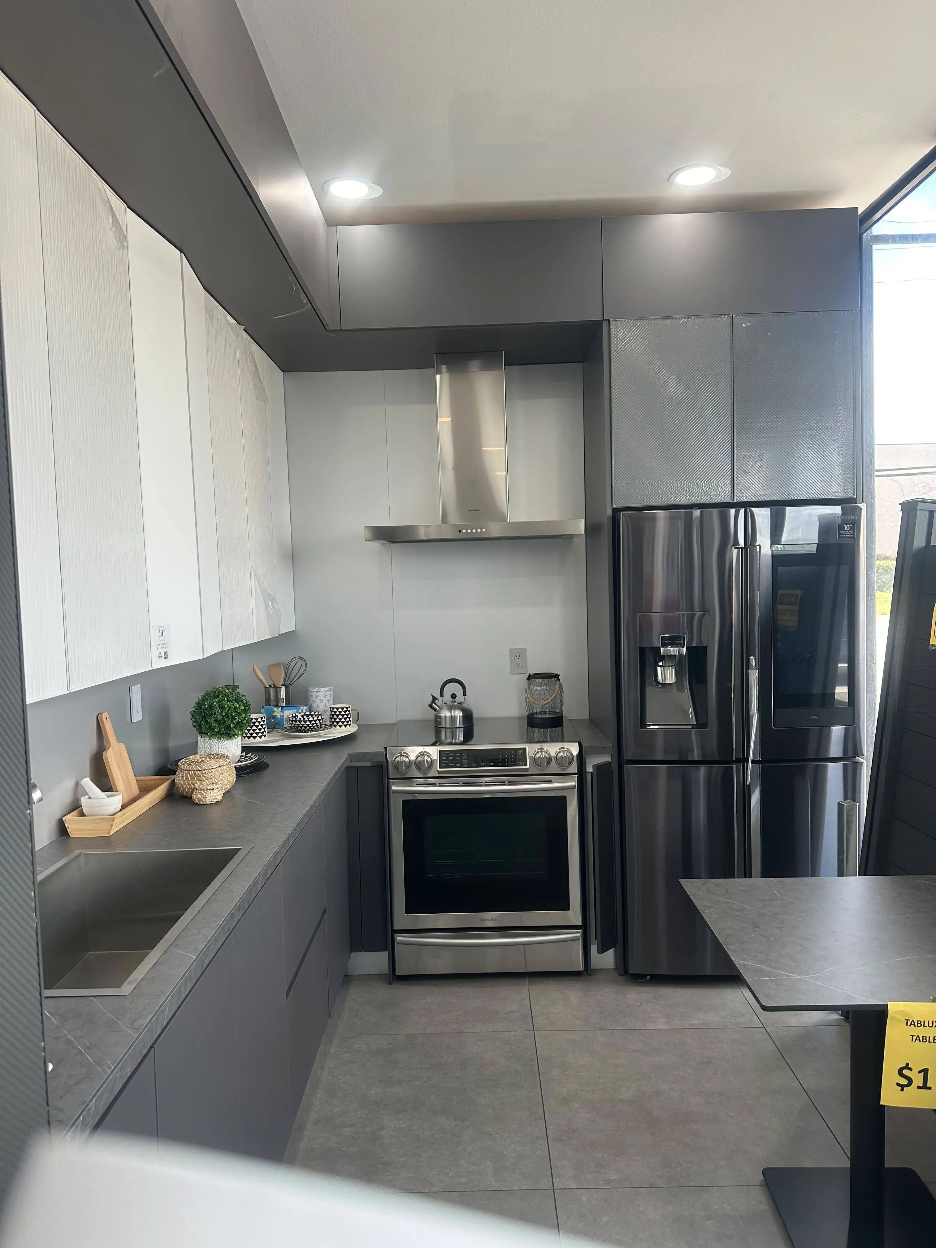 Gray and white kitchen cabinets with a range hood