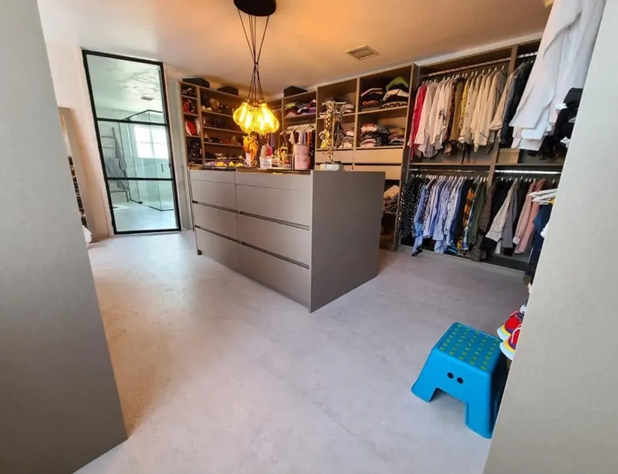 Custom closet with an island of drawers