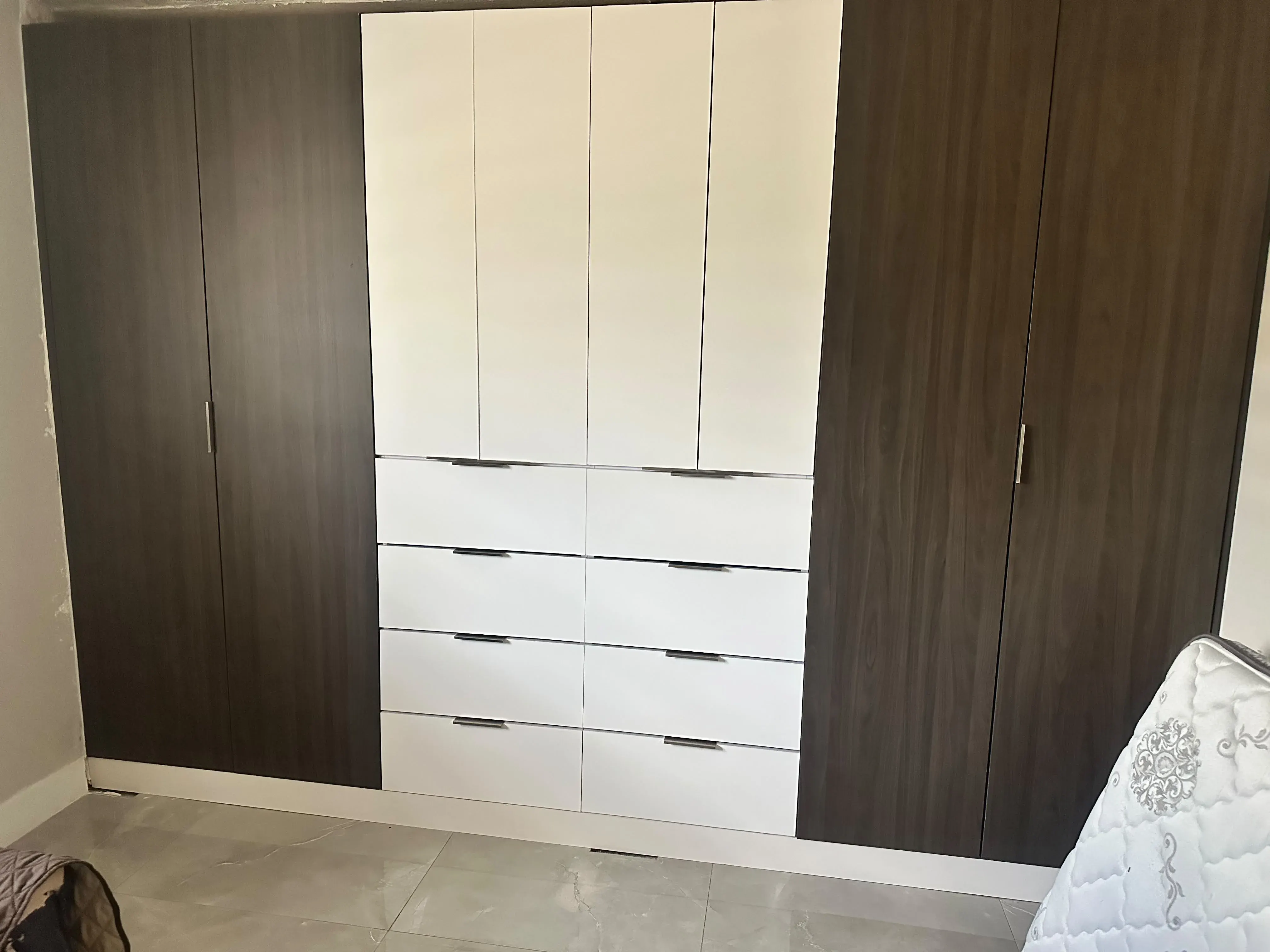 Wardrobe cabinets with white drawers and dark wood doors