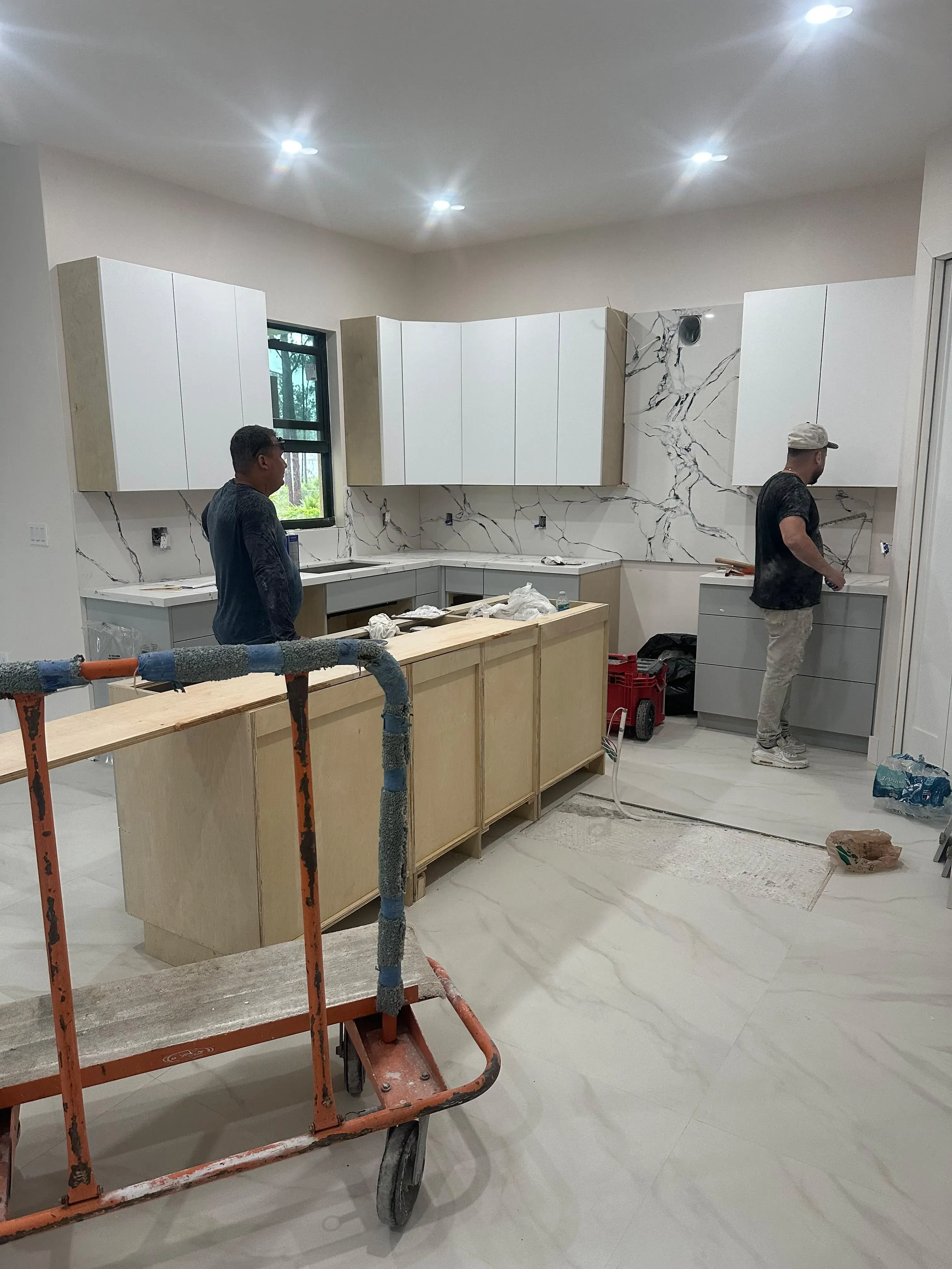 Crew installing kitchen cabinets