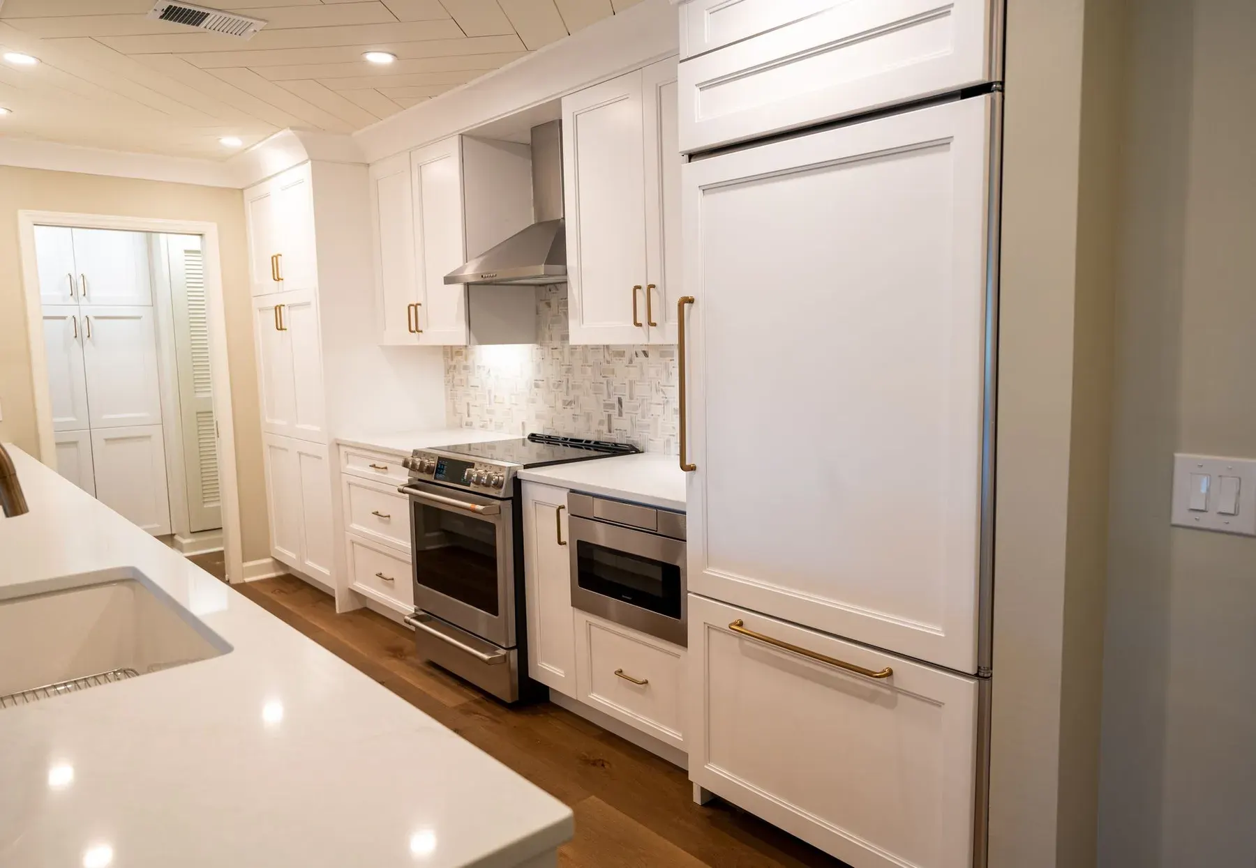 White kitchen with an island and bar stools in a Fort Myers home